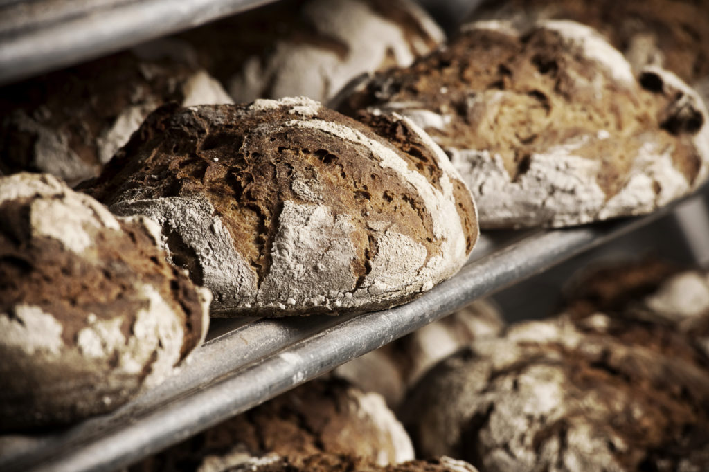 Dark brown bread buns fresh out of the oven