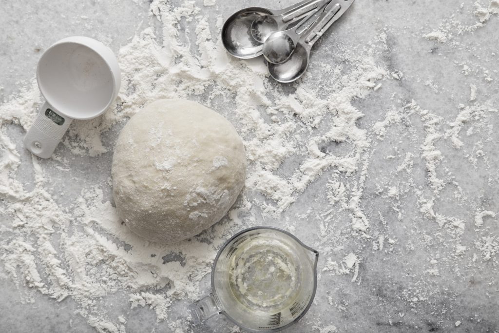 Baking bread by hand - flour, dough and watero