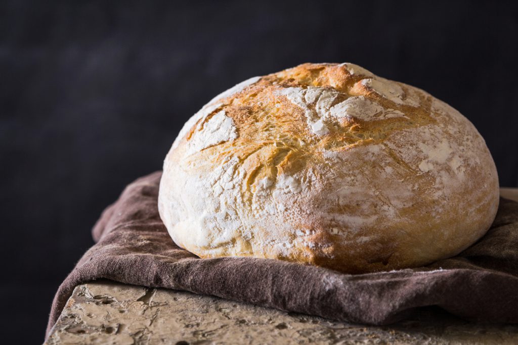 A freshly baked loaf against a dark background