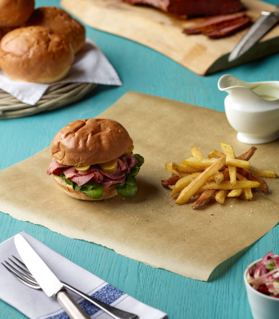 Salt Beef Buns with Radicchio Slaw, Blue Vinny Sauce and Skinny Skin on Fries illustration