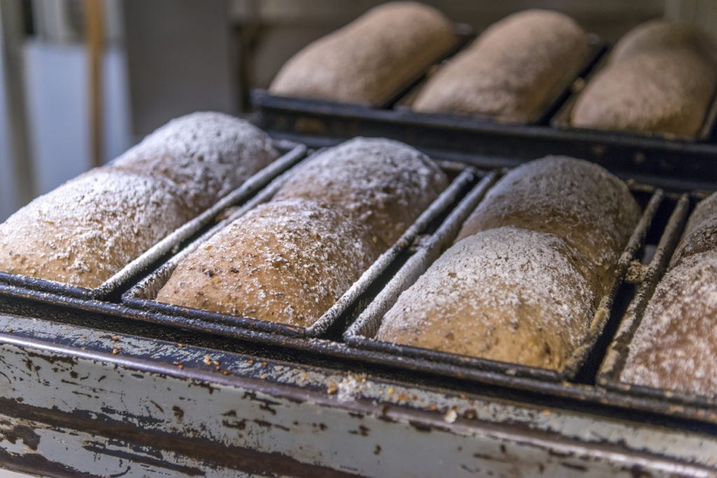 Artisan loaves of bread on calling rack.